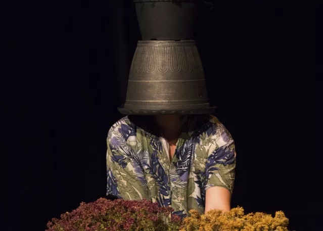 Dancer and choreographer Aliah Schwartz, with a pot of flowers on her head.